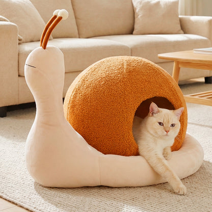 the cat furniture, a ginger cat peeking out from the snail shell opening