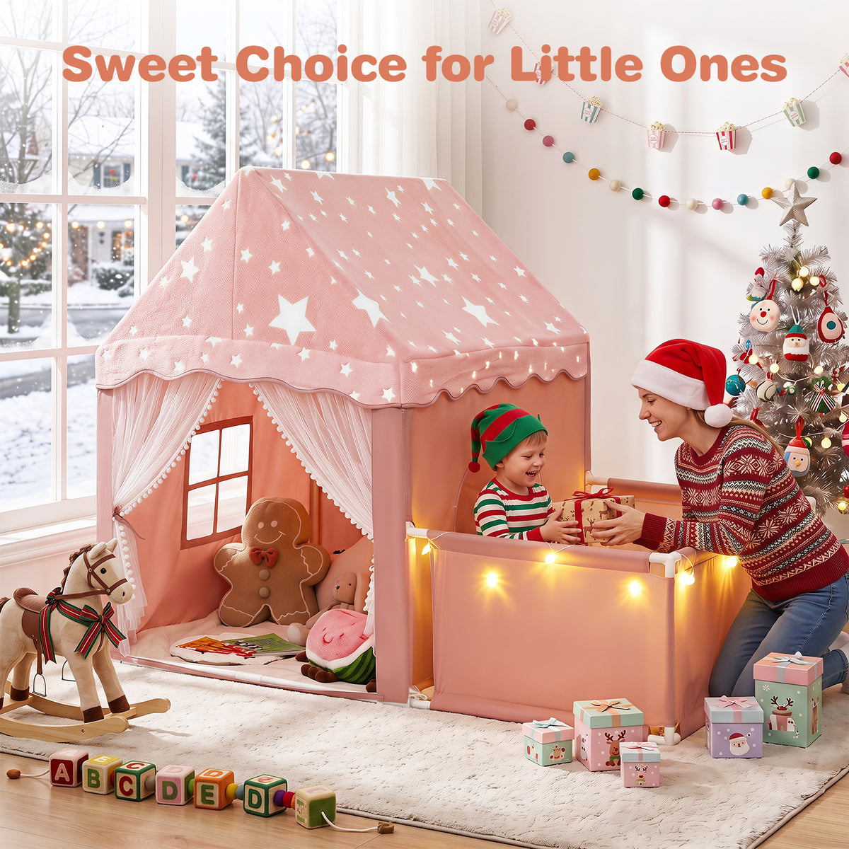 A mother and child playing with the pink play tent and playpen at Christmas