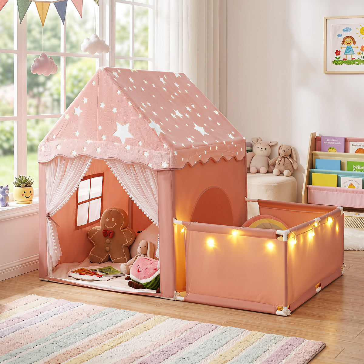 The pink play tent with side playpen set up indoors with toys and books