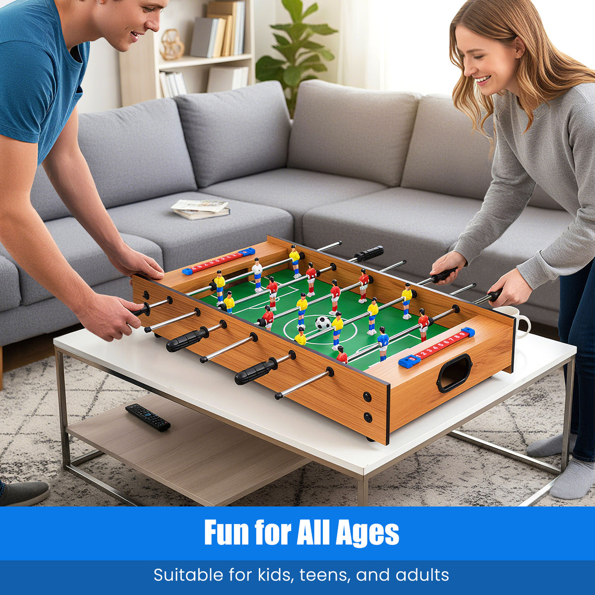 An adult man and woman playing a foosball match on the game board in a living room setting