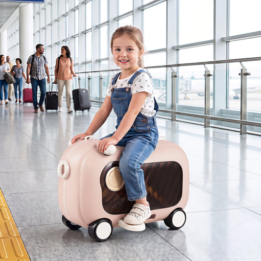Young girl riding on the pink kids luggage in an airport terminal