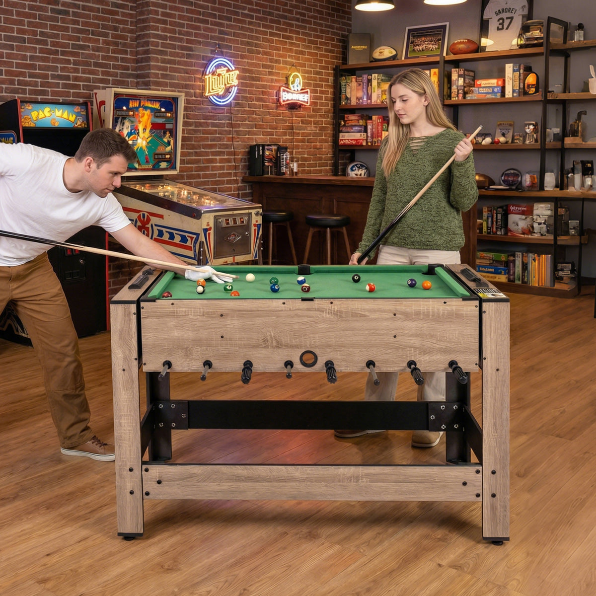 The game table set up for pool with a woman holding a cue stick in a home bar environment