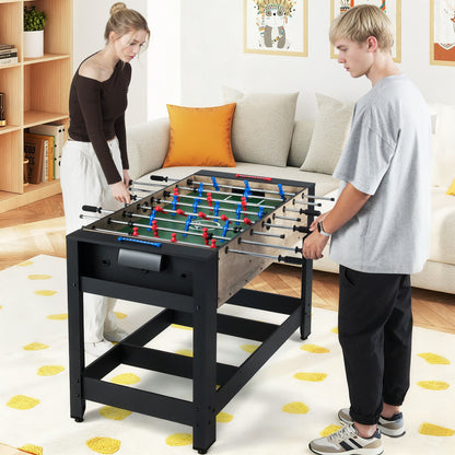 The game table set up for a foosball match with two people playing in a living room