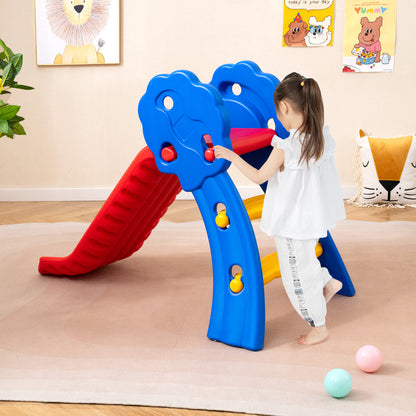 Child climbing the steps of the red and blue slide