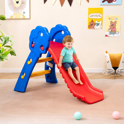 Toddler sliding down the red slide indoors