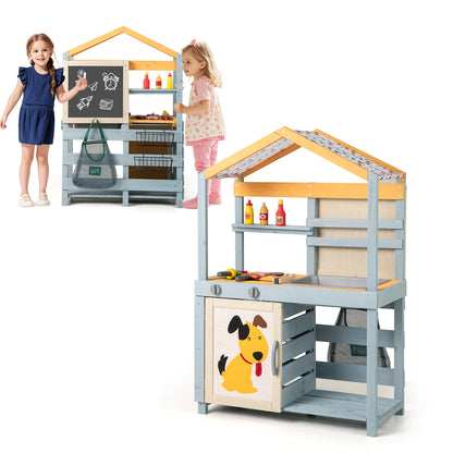 Two children interacting with the wooden mud kitchen and grocery store