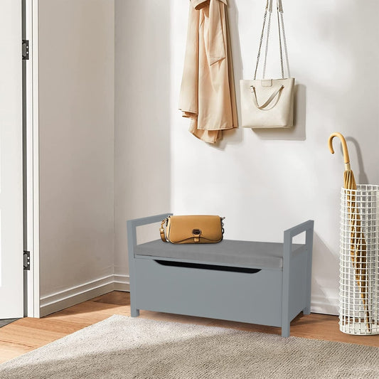 Grey wooden shoe changing bench with storage space in a hallway, with coats and bags hanging nearby