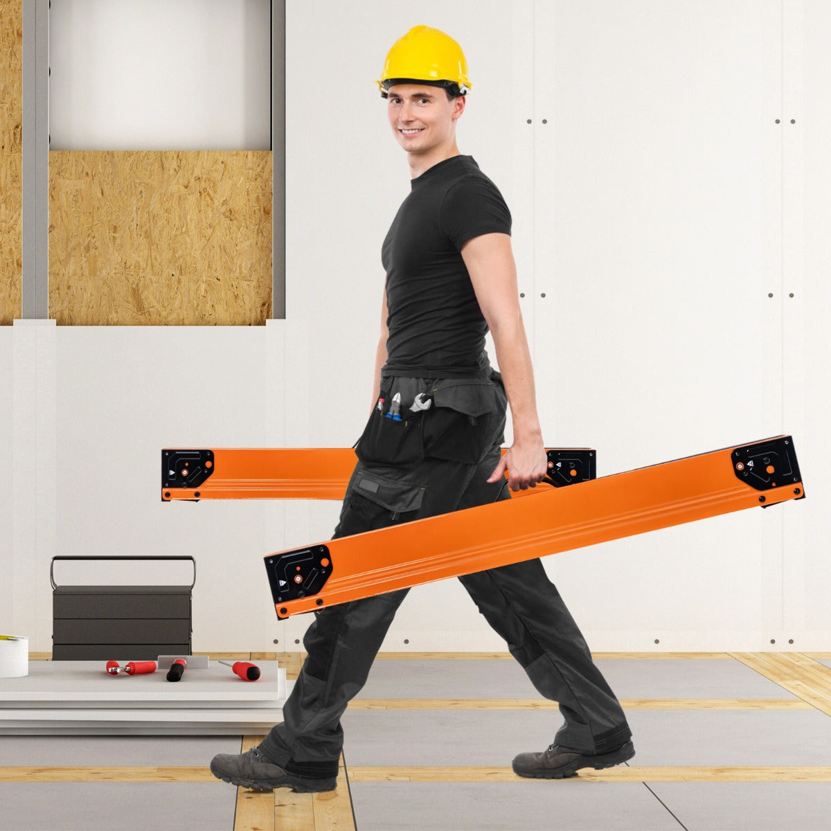 Man carrying one orange saw horse