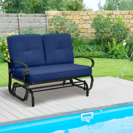 The blue patio glider chair on a wooden deck next to a swimming pool