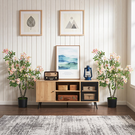 The faux plants placed on either side of a wooden sideboard in a bright living room