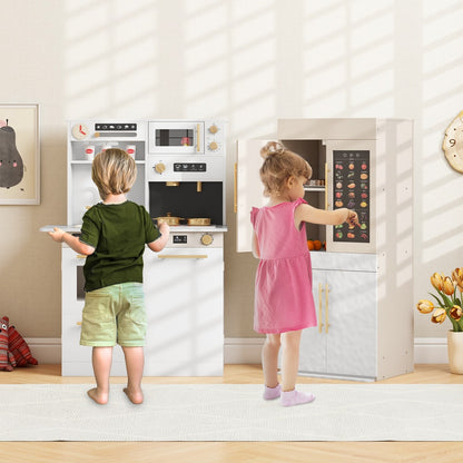 Two children playing with the white play kitchen set and refrigerator