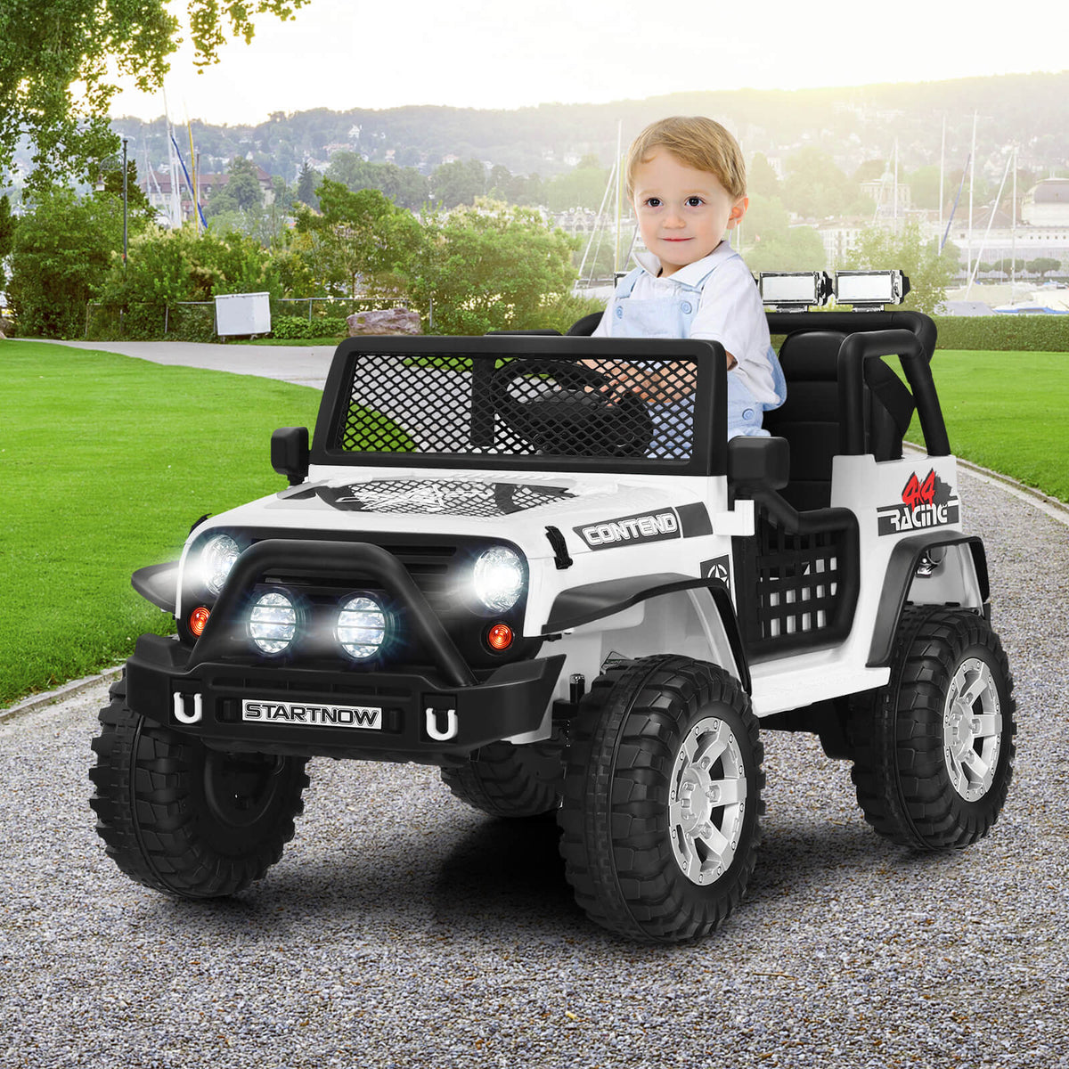 This white kids electric jeep has a child sitting in the driver's seat, ready to go