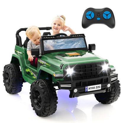 The green kids electric jeep with two children inside and a parent remote control held up