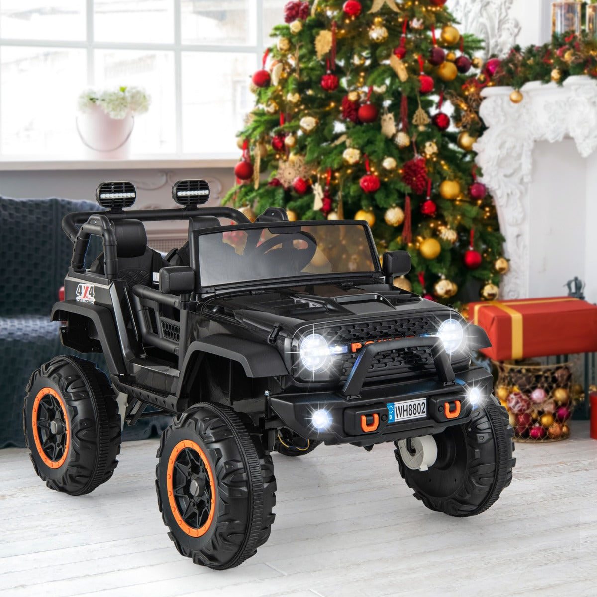 2-Seater Ride On Car, black kids electric car parked indoors in a room with a Christmas tree
