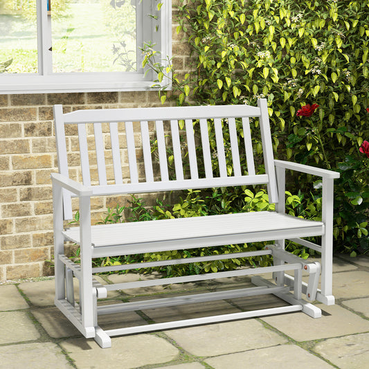 The patio glider positioned on a stone patio in front of a brick wall and climbing green plants