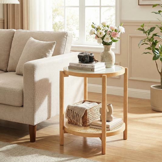 The end table placed beside a sofa in a living room with a vase and camera on top