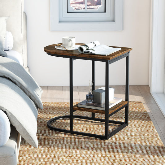 The C-shaped end table placed next to a bed with a book and cup on top