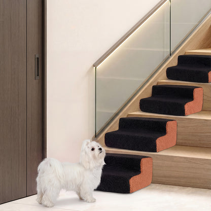A dog standing at the bottom of a staircase with pet stairs placed on steps