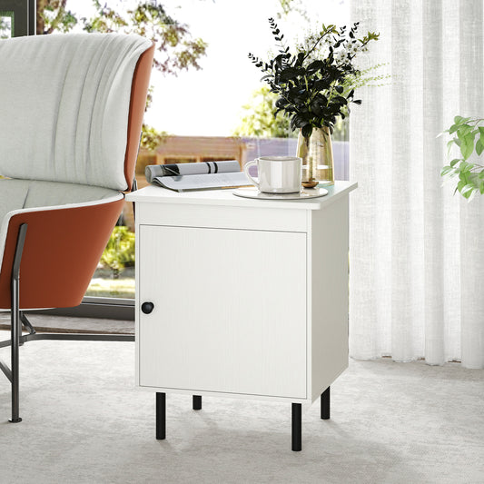The white nightstand with a single door cabinet is shown in a bedroom setting next to a chair