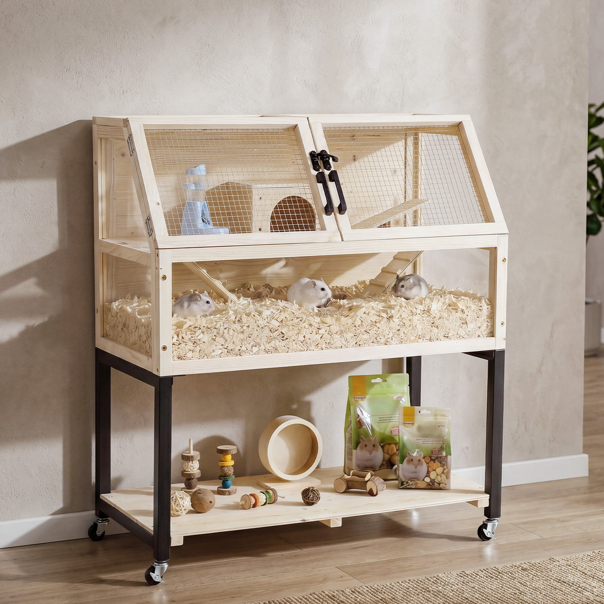 The small animal habitat shown with hamsters inside on bedding with food bags and toys nearby