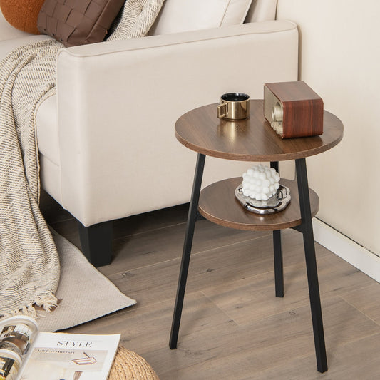 The round side table with storage shelf next to a sofa with a blanket