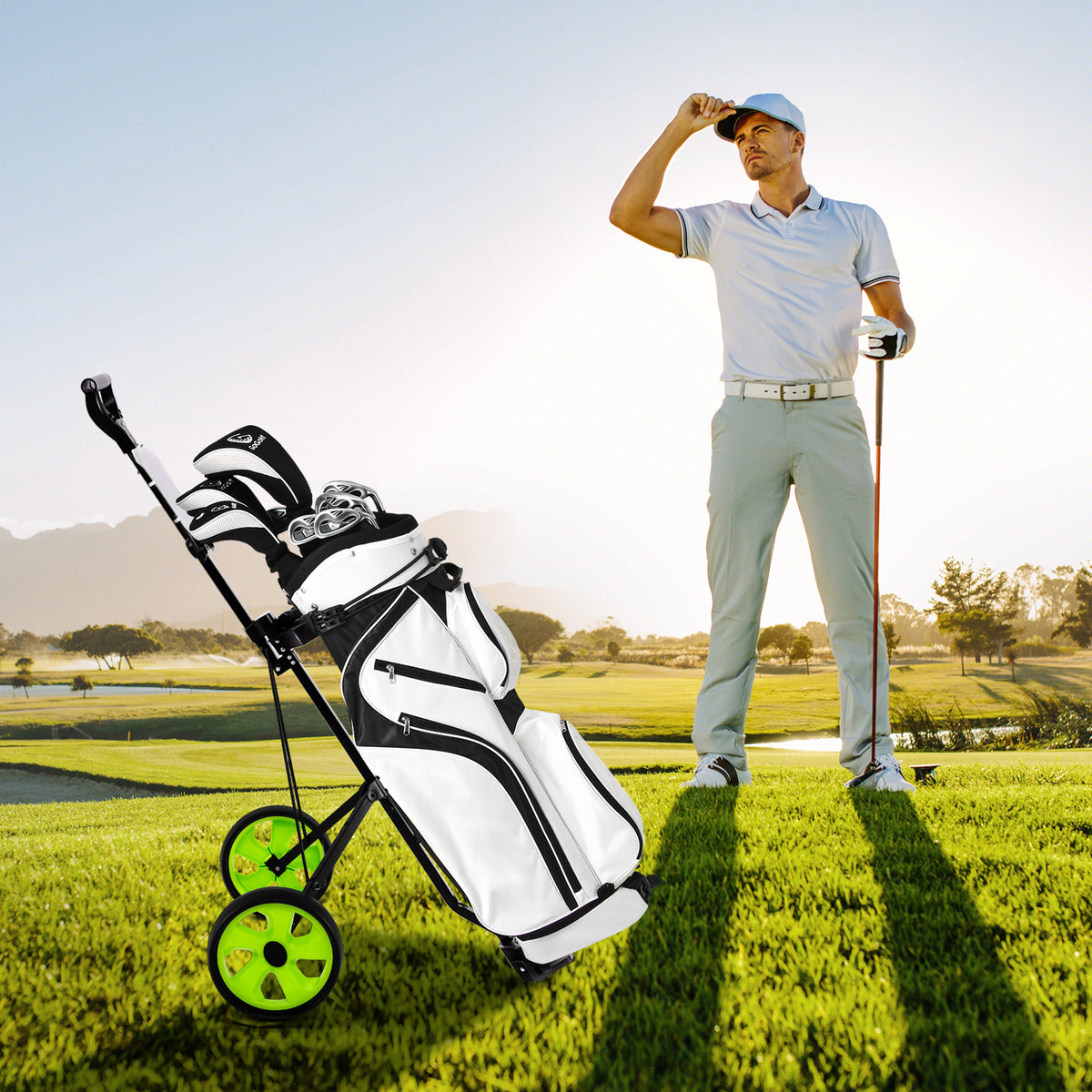 A golf bag sits on the green golf cart on a golf course with a man in the background