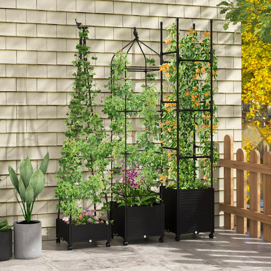 Three black metal garden obelisks with climbing plants in planters on a patio