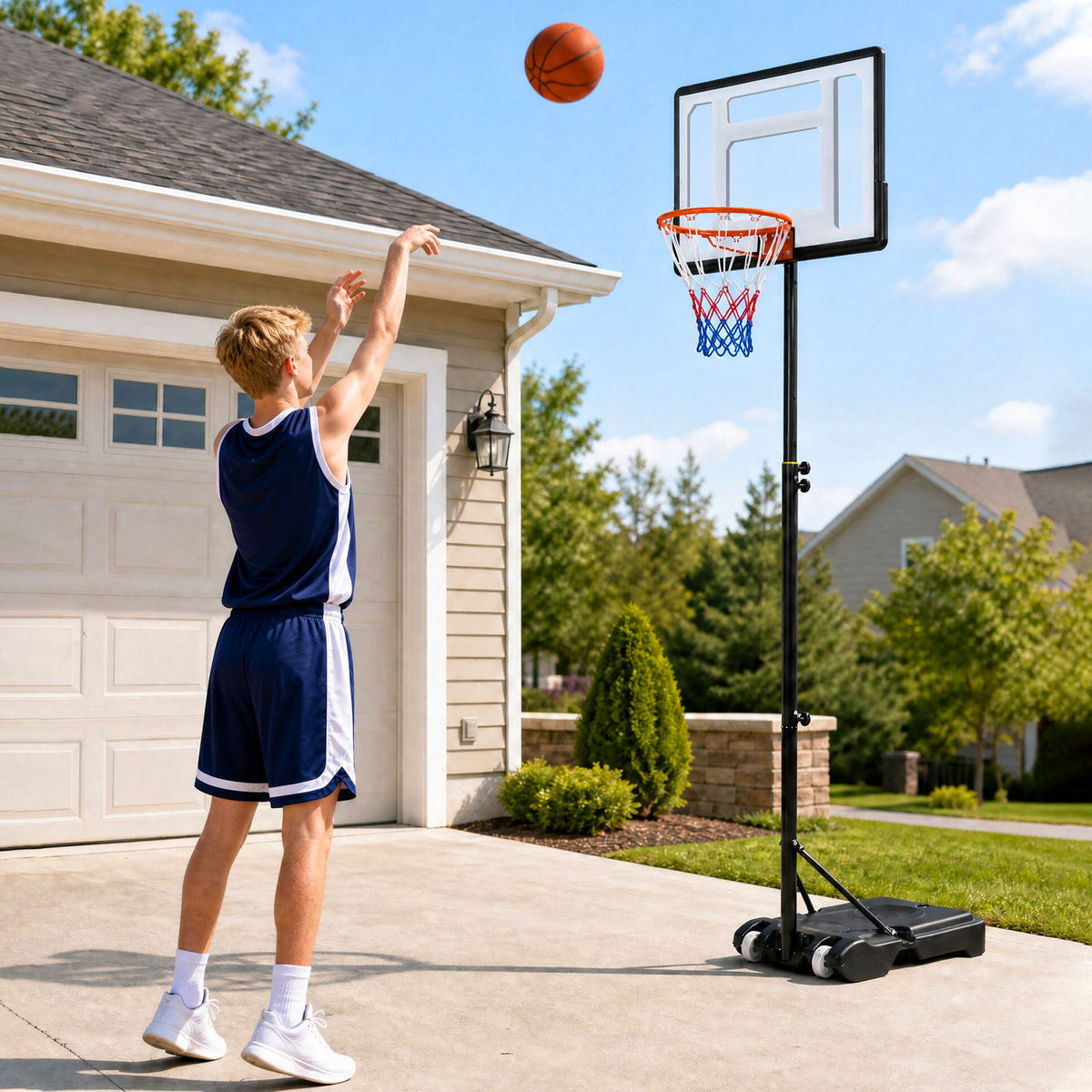 Young person shooting a basketball at the adjustable hoop in a driveway