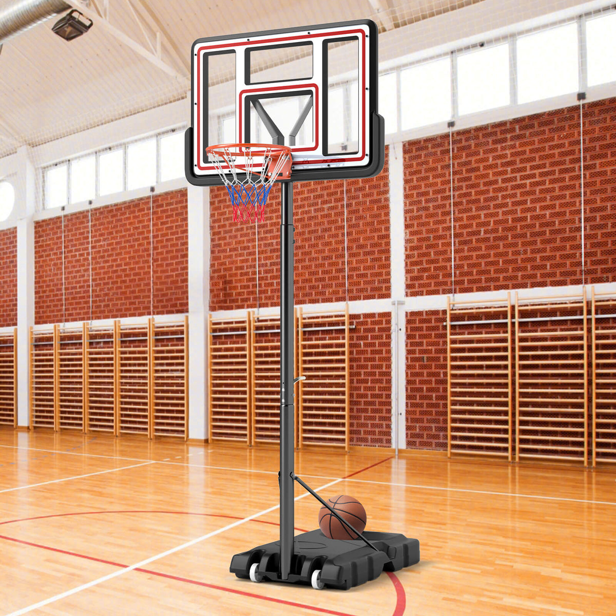 The adjustable basketball goal system set up on a wooden floor in a gymnasium
