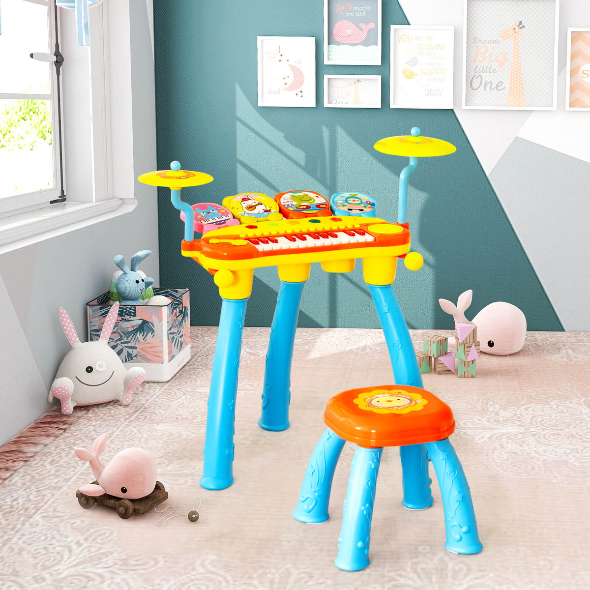 The blue and yellow toy keyboard drum set with stool is set up in a child's room