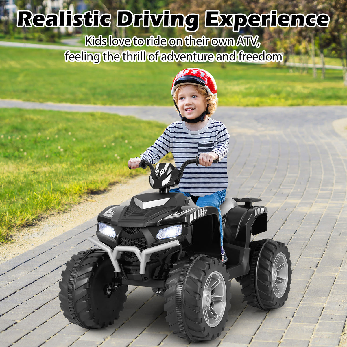 A young boy wearing a red helmet rides the black kids electric car on a paved path