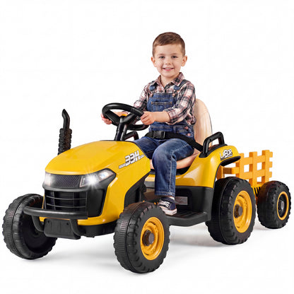 Child sitting in the yellow electric tractor with trailer