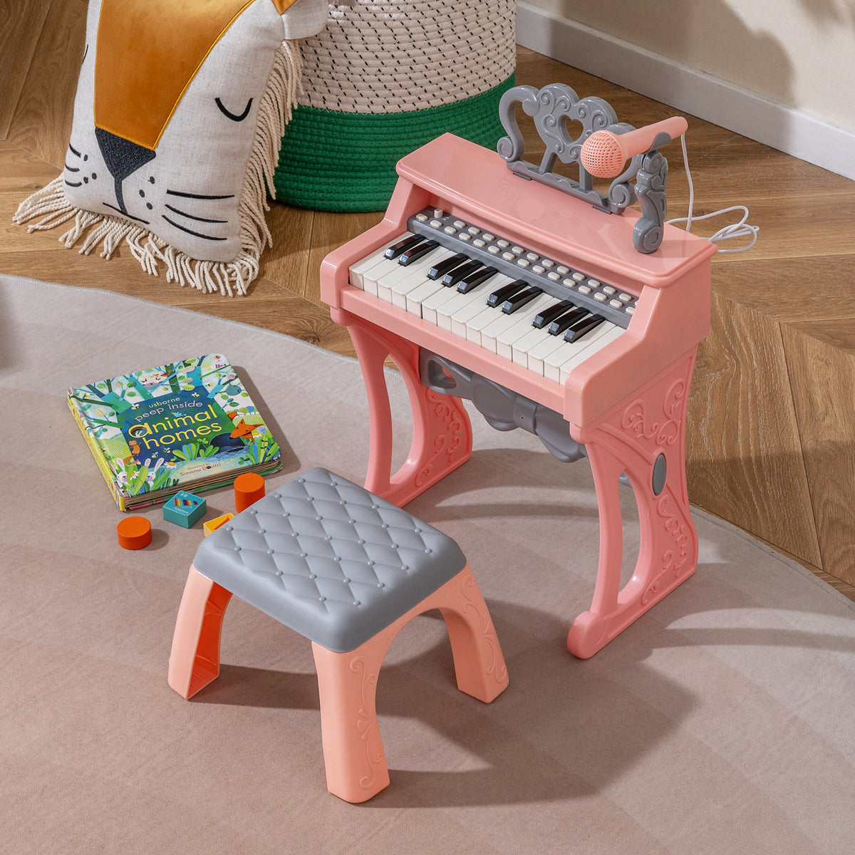 Pink keyboard piano and stool set up in a child's room