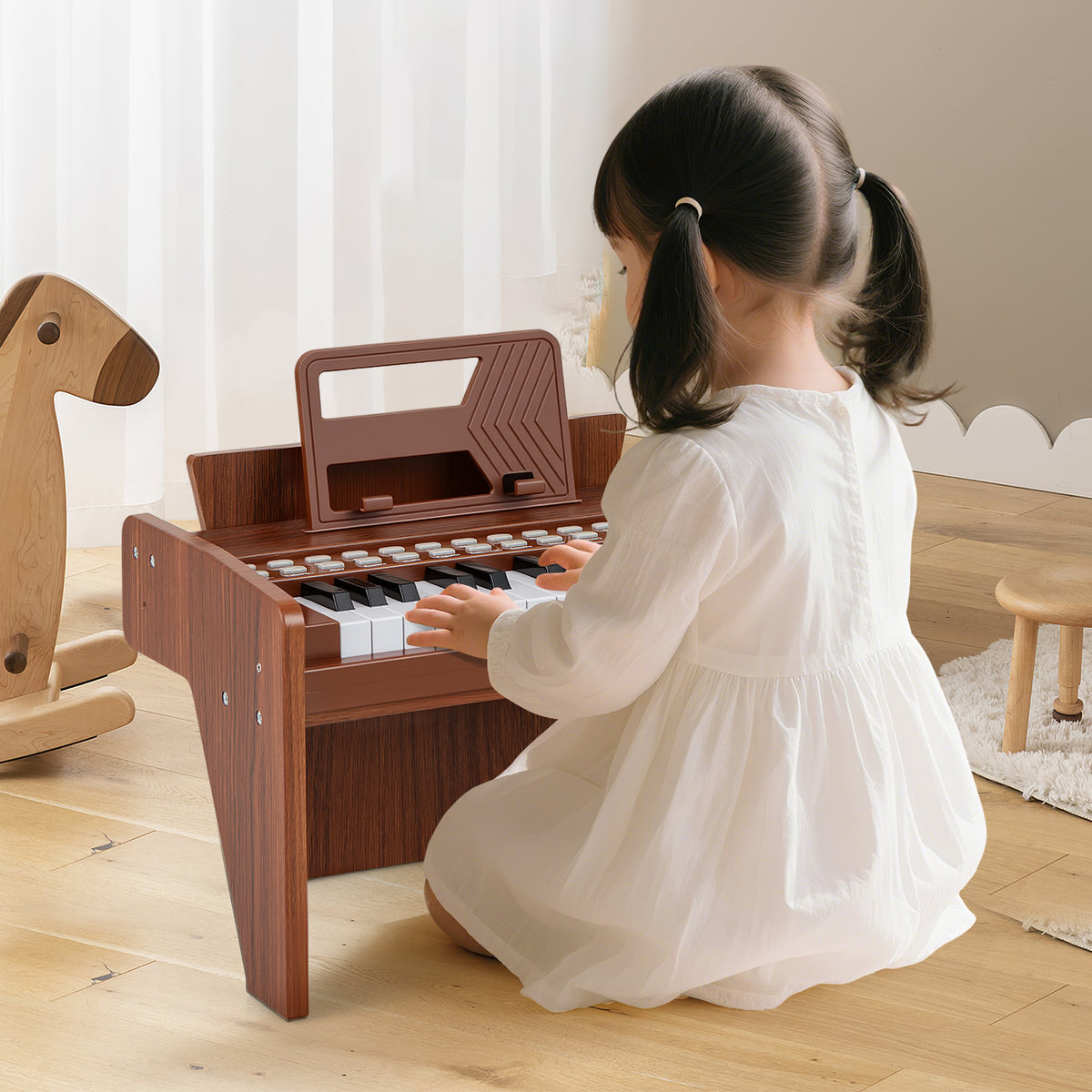 The brown wooden piano keyboard being played by a young child in a bright room