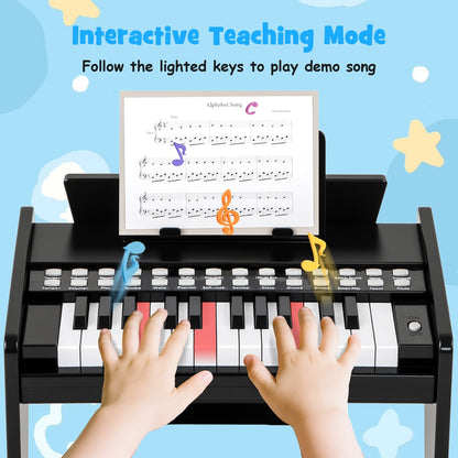 Close-up of a child's hands playing the lighted keys on the black wooden toy piano