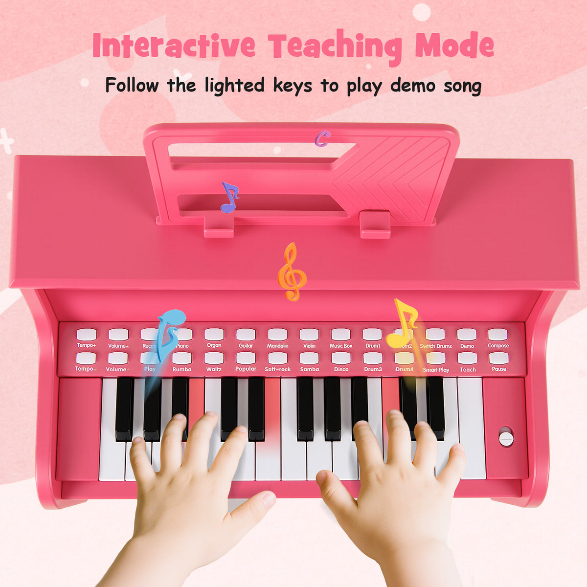Close-up of a child's hands playing the pink kids piano keyboard with lighted keys