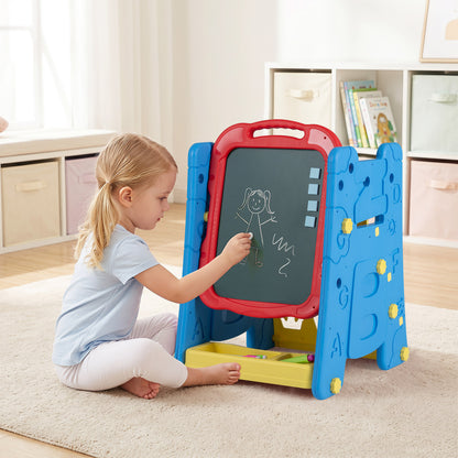 Young girl drawing on the chalkboard of the art easel
