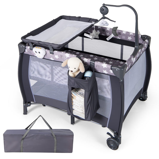 The baby playpen with a grey star pattern, changing table, and hanging toy mobile