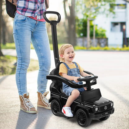 Woman pushing a baby in the black sliding walker with push handle on a pavement