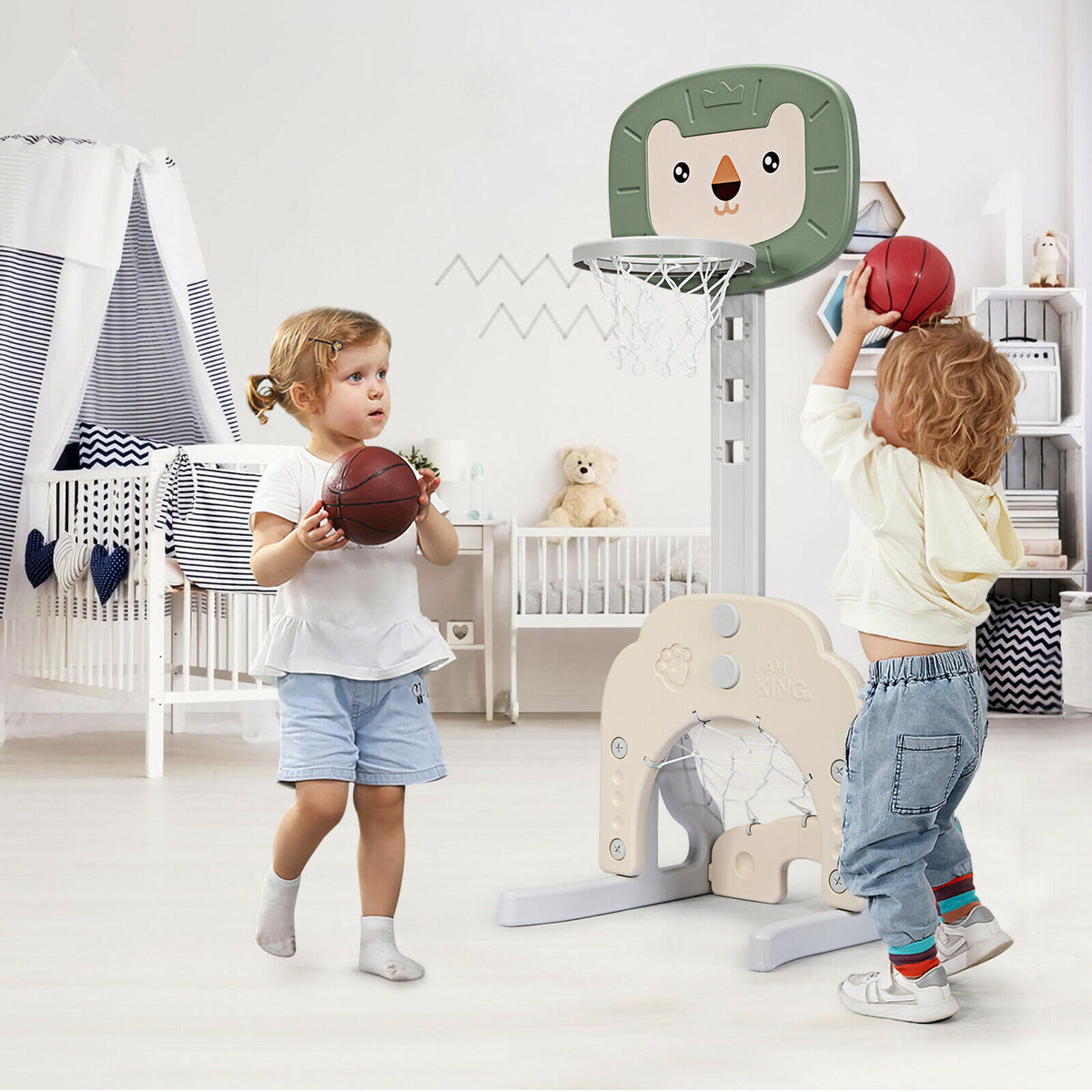 Two children playing with the toy sports basketball hoop set stand