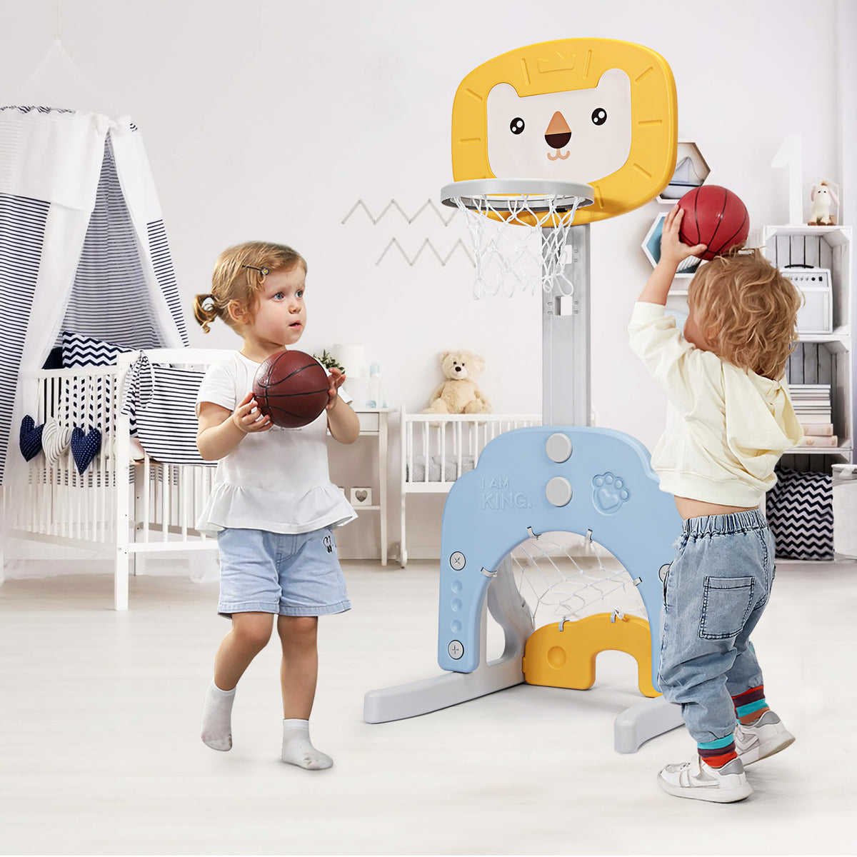 Two children playing with the 3-in-1 basketball hoop set stand indoors