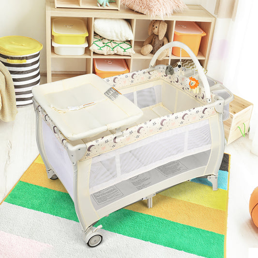 The beige baby playpen with a changing table and toy bar in a nursery