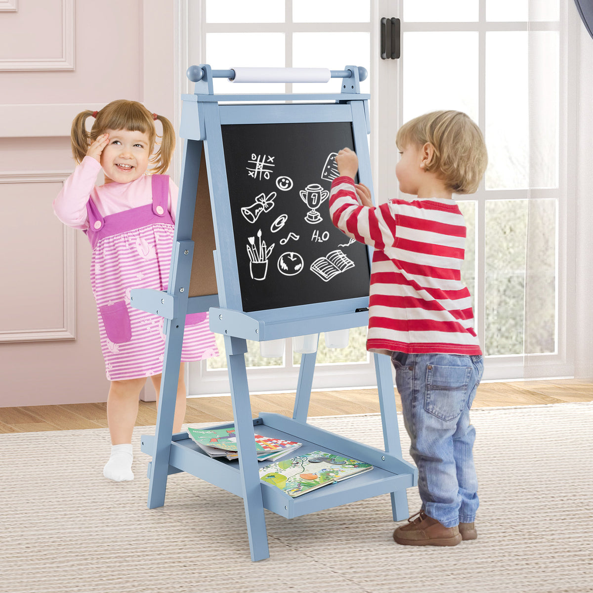 the art easel being used by two children drawing on the blackboard side