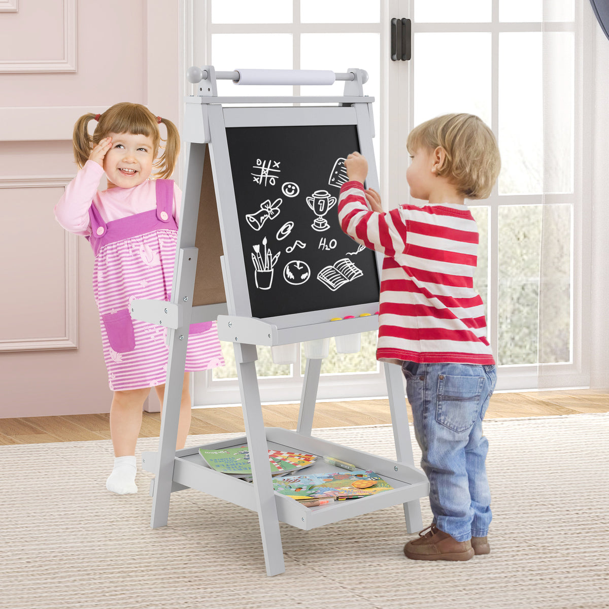Children using the grey double-sided art easel in a room