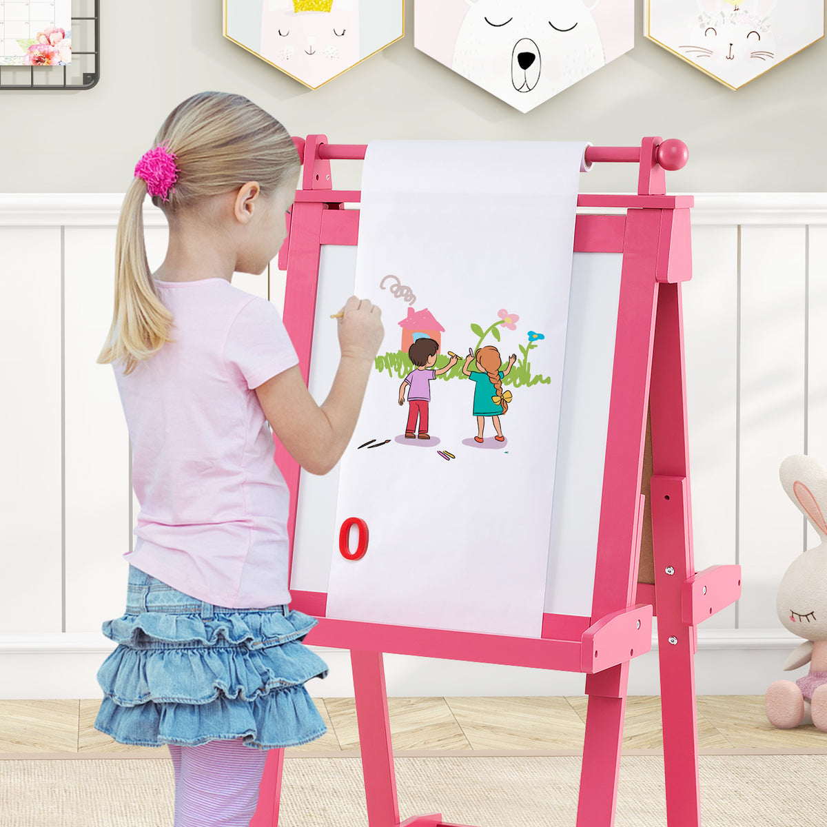 the art easel with a paper roll pulled down for a child to draw on with colourful markers