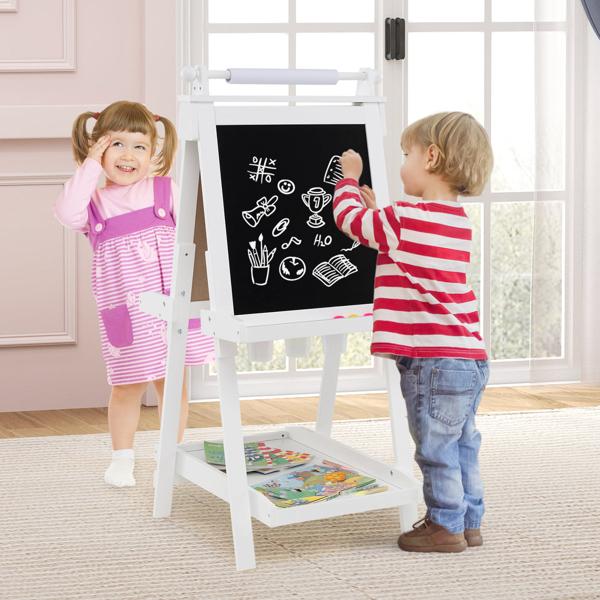 the art easel being used by two children drawing on the chalkboard side in a bright room