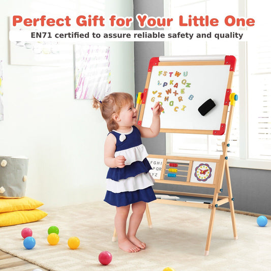 A young child happily drawing on the whiteboard of the kids art easel