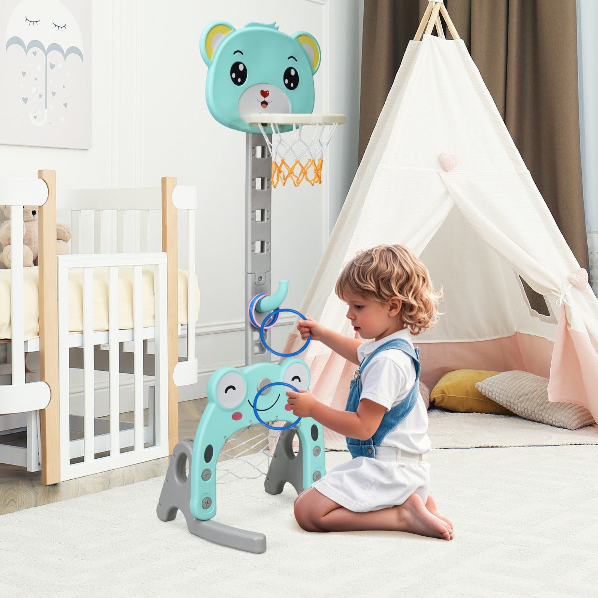 Toddler playing with the green toy sports hoop and stand set in a nursery room