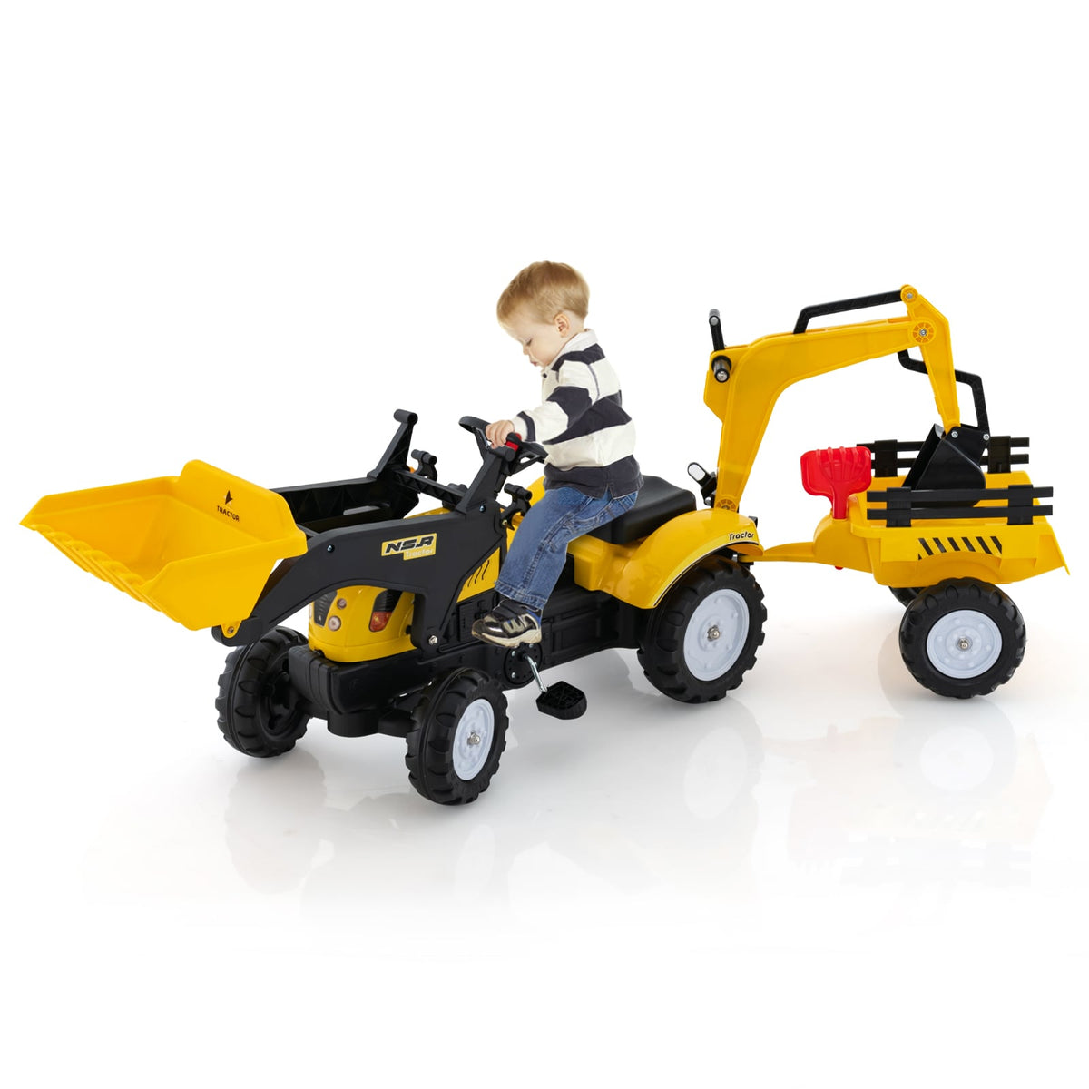 Side view of a child riding the yellow and black pedal excavator toy with trailer
