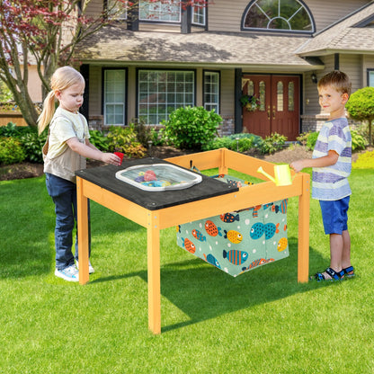 Children playing with the activity table in a garden setting